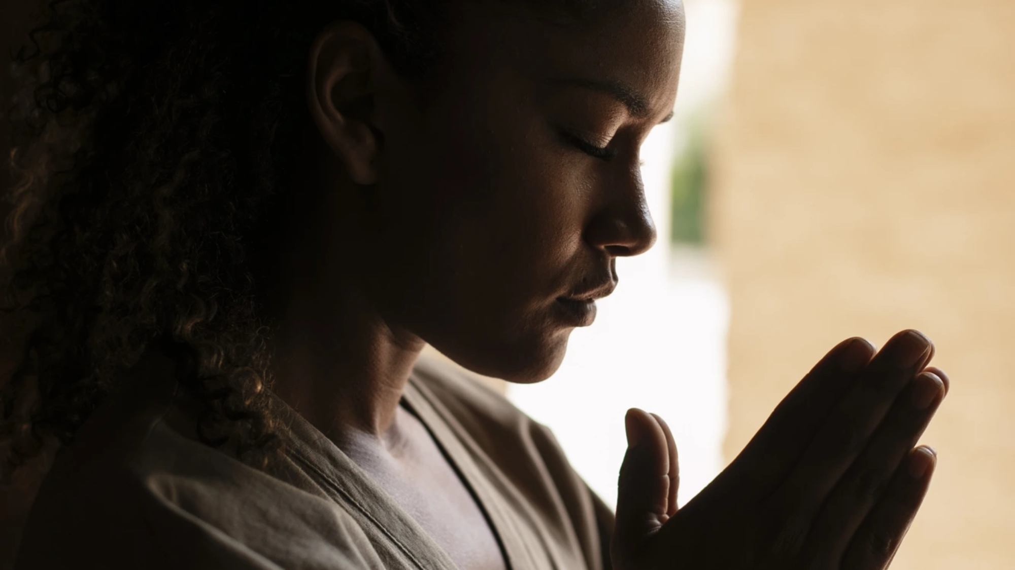 medium-shot-young-woman-praying-SQ