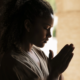 medium-shot-young-woman-praying-SQ